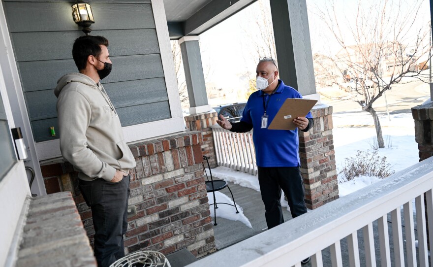 Chaz Tedesco, who serves on the Adams County Commission, asks for a petition signature from neighbor Ryan Goff as he canvasses on Jan. 29. Tedesco is running for Colorado's 8th Congressional District.
