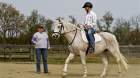 Army Sgt. Jonathon Biddle listens to directions from Suzie Stricker, a Maryland Therapeutic Riding Horses for Heroes instructor, while riding his horse, May, during a lesson at Maryland Therapeutic Riding in Crownsville, Md., April 4, 2012.
