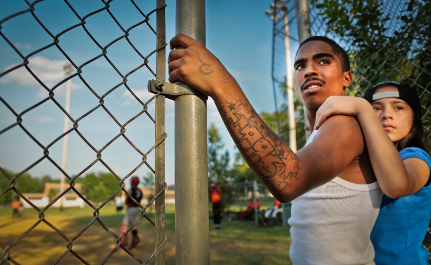 Joey Perez and Tiana Reyes watch Miguel's team play at Pyne Poynt. Joey plays in the 16- to 18-year-old league. Joey and Miguel are cousins; they live with their grandmother Maria and were raised as brothers.