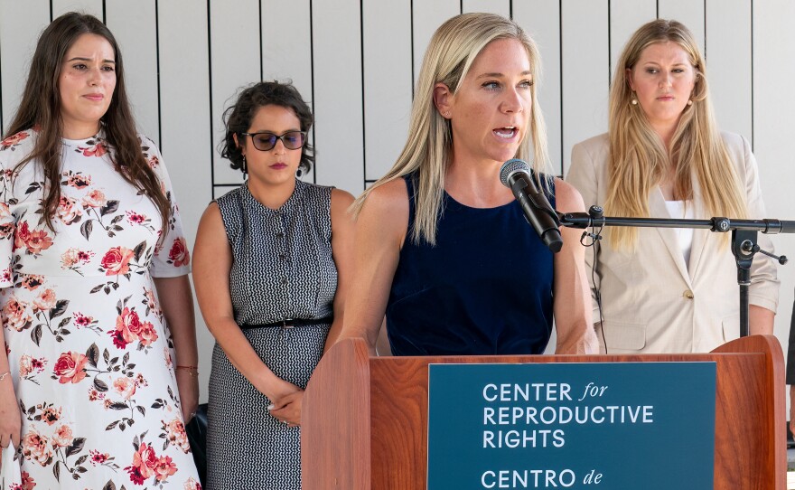 Amanda Zurawski speaks during a press conference outside the Travis County Courthouse on July 19, 2023. Ashley Brandt, Elizabeth Weller and Lauren Miller stand behind her.