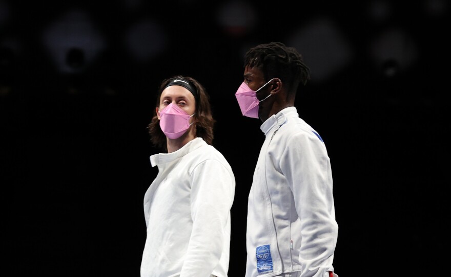 American's Jacob Hoyle and Curtis McDowald wear pink face masks after losing to Japan in Men's Épée.