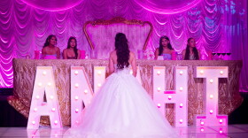 Anahi Sareñana talks to her friends while on stage during her quinceañera at the Factory of Dreams hall in Chula Vista, May 31, 2026.