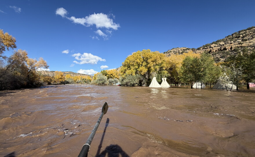 Aaron Schenk rafted down the flooded Animas River in southwestern Colorado  on Friday. He passed by an inundated event space.
