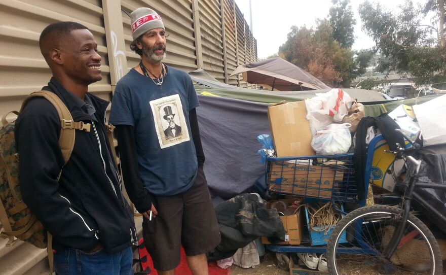 Jesse Henderson (left), an Army veteran, walks Hollywood Boulevard in Los Angeles looking for homeless veterans. His job is to try and connect them with support resources, including transitional housing, offered by the nonprofit U.S.Vets.