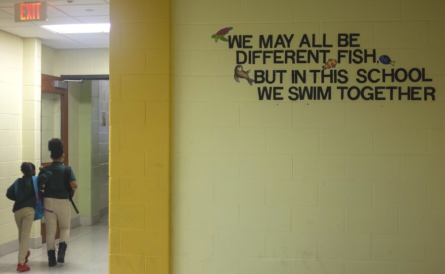 A sign in the hallway at Crocker College Prep. Here, students are no longer automatically punished for disruptive behavior. A new approach aims to catch and understand kids whose behavior may be a response to trauma.