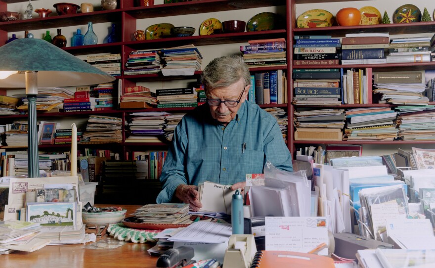 Donald Brown organizes postcards inside his home in Myerstown, Pa., on June 24, 2022.
