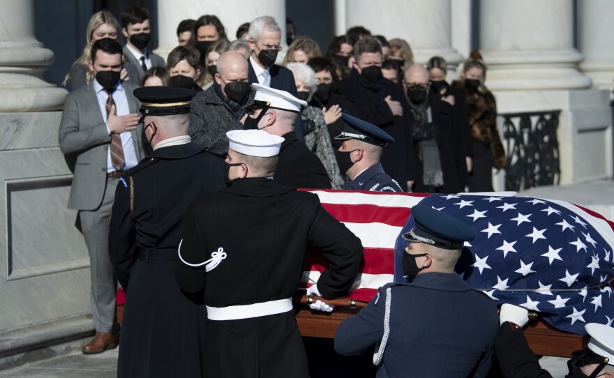 Family members including Josh Reid, Rory Reid and Landra Gould watch as a U.S. Joint Forces bearer team carries the casket of former Senate Majority Leader Harry Reid into the U.S. Capitol.
