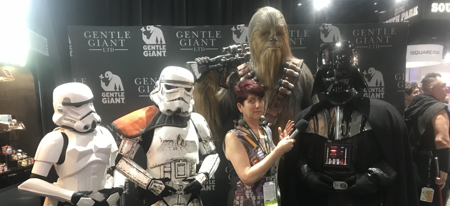 KPBS arts reporter Beth Accomando experiencing some Imperial entanglements at Comic-Con. From the 501st Legion: (L-R) Leslie Camerino (Stormtrooper), Dan Deaver (Sandtrooper), and Andy SalmonsenI (Darth Vader), and Chewbacca was a prop by Gentle Giant and therefore not much help in actively fighting evil that day. July 22, 2018