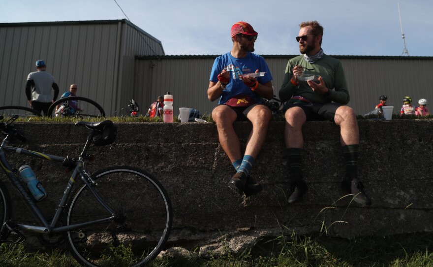 Alex Brooks of Minneapolis, Minn., (left) and Tim Connors of Robinsdale, Minn., eat slices of pie Tuesday, July 26, during a pit stop in Rolfe, Iowa. Connors said they were trying to eat a different slice of pie every day, with strawberry rhubarb, a childhood favorite, ranking as his top slice so far. "That's because the key ingredient in pie is nostalgia," Connors quipped.