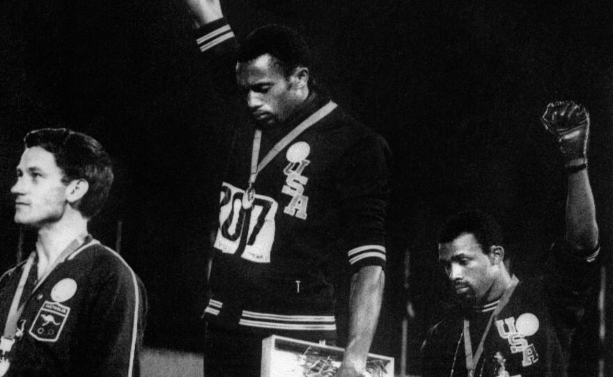 U.S. athletes Tommie Smith and John Carlos raise their gloved fists at the Mexico City Olympics in 1968 to express their opposition to racism in the U.S.