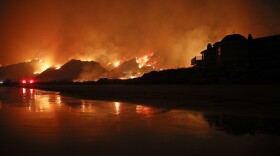 A wildfire burns along the 101 Freeway in Ventura, Calif., Tuesday, Dec. 5, 2017. 