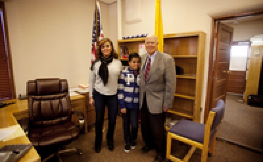 Phillip Skinner, former real estate developer and maquiladora owner-turned politician and school bus driver, stands with his wife, Diana, and son, Matthew, 10, moments after his mayoral inauguration.