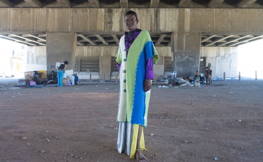 A transgender woman who goes by Joan Collins, 60, poses under the bridge in Cape Town where she and a group of transgender sex workers live.