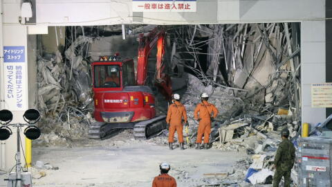 Heavy machinery removes debris at AEON Mall, which was damaged by an explosion following an earthquake, in Kashima, Kumamoto Prefecture, southern Japan, Friday, July 31, 2026.