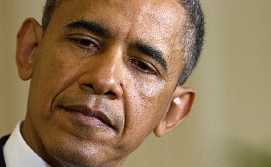 President Barack Obama listens as British Prime Minister David Cameron speaks, during their joint news conference Monday.