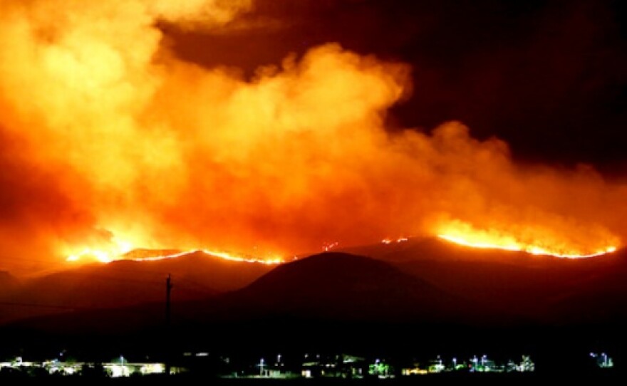 U.S. Marines and fire crews at Marine Corps Base Camp Pendleton battle wildfires at night, May 14, 2014.