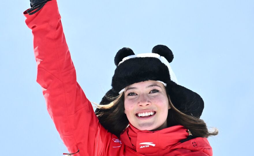 Gold medalist Eileen Gu, competing for China, poses on the podium during the venue ceremony after the freestyle skiing women's freeski halfpipe on Friday.