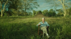 E.O. Wilson sitting in front of anthill, Gorongosa, Mozambique.