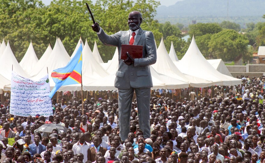 South Sundanese, watched over by a statue of rebel leader John Garang, celebrate their independence day in the capital, Juba, in 2015. This year, there will be no such celebrations.
