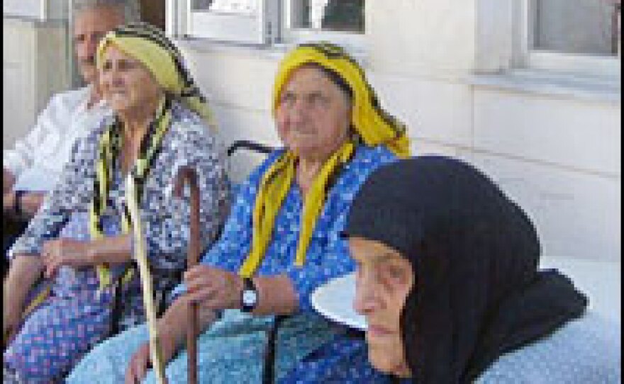 Elderly Makrihori villagers gather at a local cafe. Many of them lost their homes, crops and livestock during the fires.