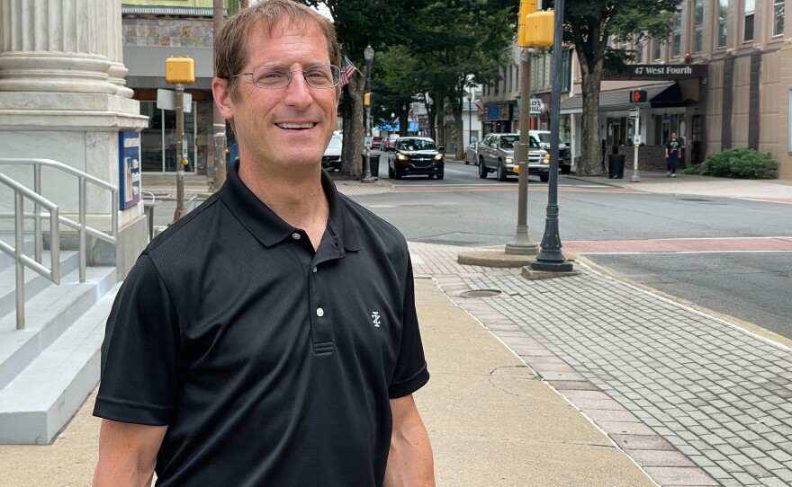 Williamsport Lycoming Chamber of Commerce President and CEO Jason Fink stands on a street in downtown Williamsport, Pa.