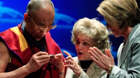 House Speaker Nancy Pelosi (D-CA) (R) presents the Dalai Lama (L) with the Lantos Human Rights Prize as Annette Lantos (C) looks on during a ceremony at the U.S. Capitol on October 6, 2009 in Washington, DC. 