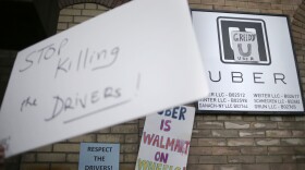 Uber drivers and their supporters rally at an Uber office in New York, Feb. 1, 2016. 