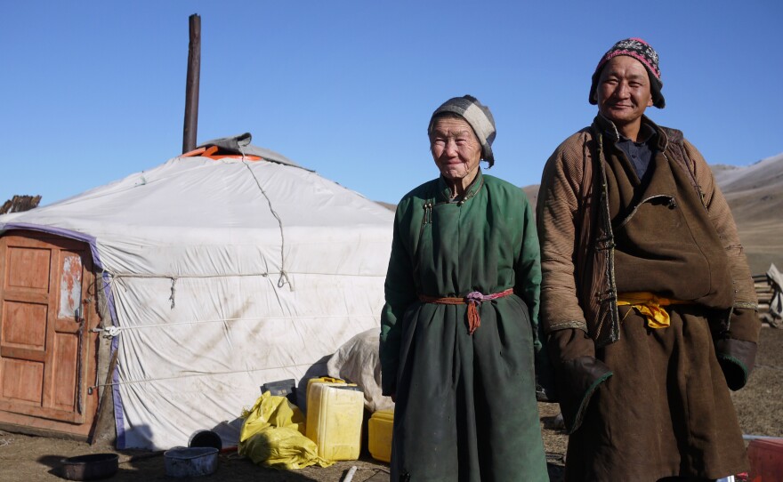 Nomadic herders Lkhagvajav Bish, 90, and her son, Tsahiur Rentsenkhorloo, stand outside their ger in northeastern Mongolia. "All I can do is watch my grassland disappear," says Bish.