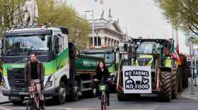 Cyclists ride past tractors blocking O'Connell Street on the fifth day of the National Fuel Protest, in Dublin, Ireland, on Saturday.