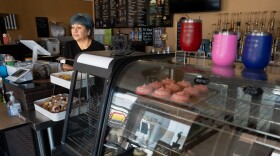 Elsa Ordona leans against the register awaiting her second rush at Sweet Nothings Pastry and Coffee Shoppe in El Centro, Calif. on June 5, 2024.