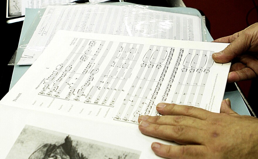 Lotoro displays a copy of music by Rudolf Karel, a Czech composer (in 1945 sketch at left) imprisoned by Nazis for helping the resistance in Prague, in a music shop in Rome, Feb. 22, 2007. Denied access to regular paper, Karel wrote his compositions down on toilet paper. He died of dysentery at the Terezin camp.