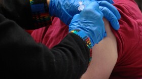 A man getting vaccinated against COVID-19 at San Diego State's Viejas Arena, March 23, 2021.