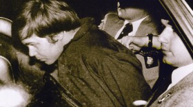 John Hinckley Jr. is escorted by police in Washington, D.C., on March 30, 1981, following his arrest after shooting and seriously wounding then-President Ronald Reagan. 