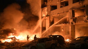 Emergency services personnel work to extinguish a fire following Russian missile attacks in Kyiv, Ukraine, Monday, July 6, 2026.