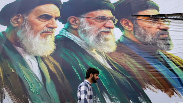 A man walks past a billboard featuring the portraits of (right to left) Iran's new Supreme Leader Ayatollah Mojtaba Khamenei, the late Supreme Leader Ayatollah Ali Khamenei, and the late Supreme Leader Ayatollah Ruhollah Khomeini, in Srinagar, Jammu and Kashmir, on June 15.