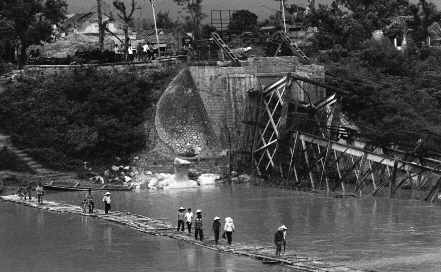 Vietnamese cross the Ky Cuong River on a temporary floating bridge in August 1979. The main bridge was destroyed by the Chinese during a brief border war several months earlier. Vietnam and China have been rivals for centuries and the friction continues to this day.