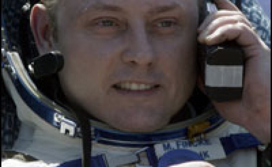 U.S. astronaut Michael Fincke speaks on a satellite phone shortly after returning to Earth aboard a Soyuz capsule on April 8 following a mission aboard the international space station.