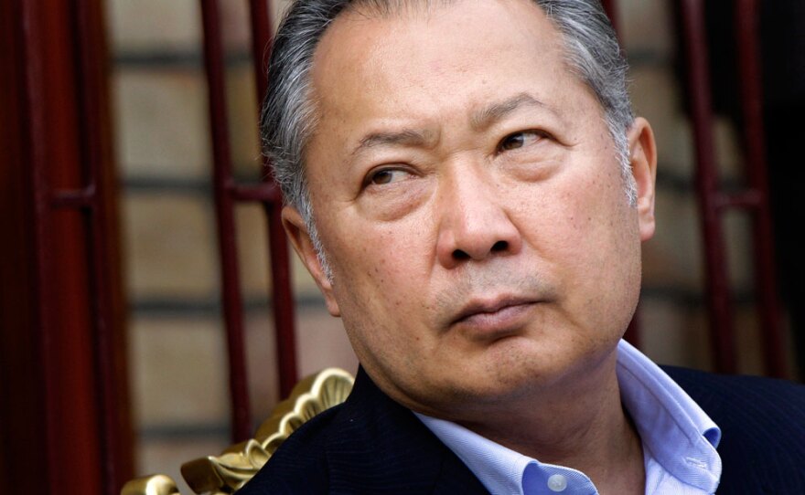Kyrgyzstan's deposed President Kurmanbek Bakiyev looks on as his supporters deliver speeches Sunday in the courtyard of his family home in the village of Teyit in southern Kyrgyzstan.