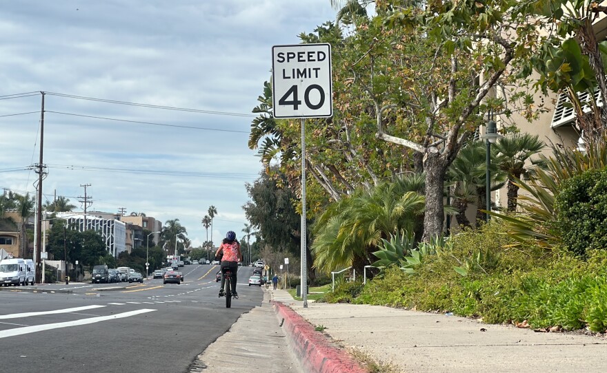 A cyclist rides past a 40 mph speed limit sign on West Point Loma Boulevard, Nov. 29, 2023.