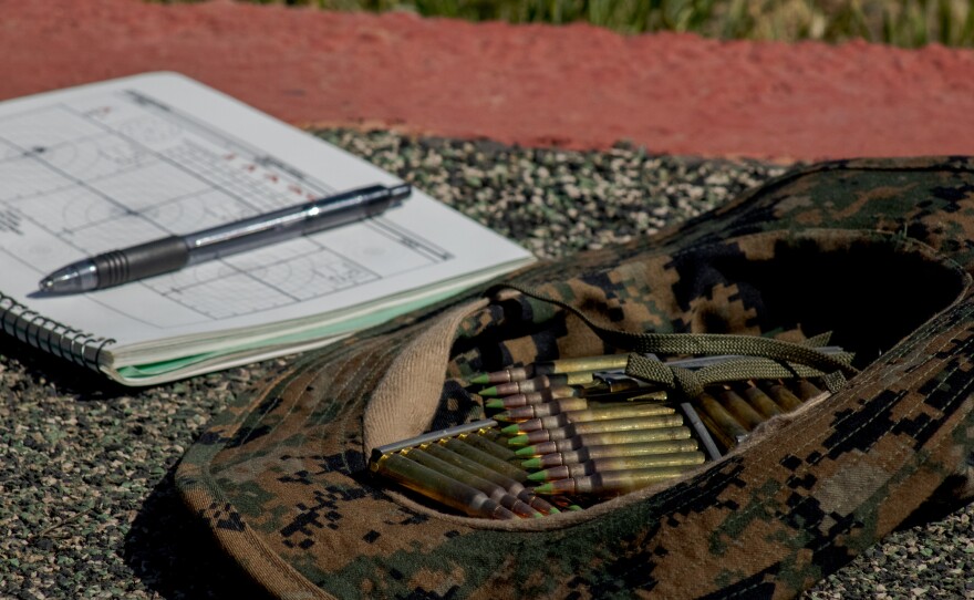 A Marine recruit's Rifle Training Databook alongside some M-16 ammunition in a cap at the Bravo shooting range on Camp Pendleton, April 7, 2021.