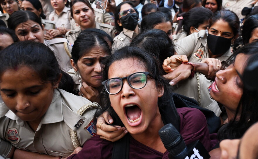 Prominent student leader Neha Bora, center, shouts slogans as she is detained by the police during a youth demonstration demanding the resignation of the country's election chief Gyanesh Kumar, in New Delhi, India, Friday, Oct. 16, 2026.