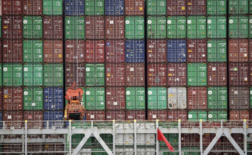 Cargo containers are stacked on a ship at California's Port of Los Angeles. Consumer goods are arriving from China and elsewhere, but a lot is not getting to its destination.