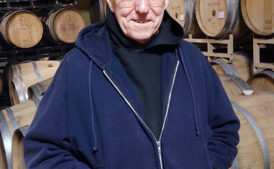 Brother Thomas serves wine at a tasting party.