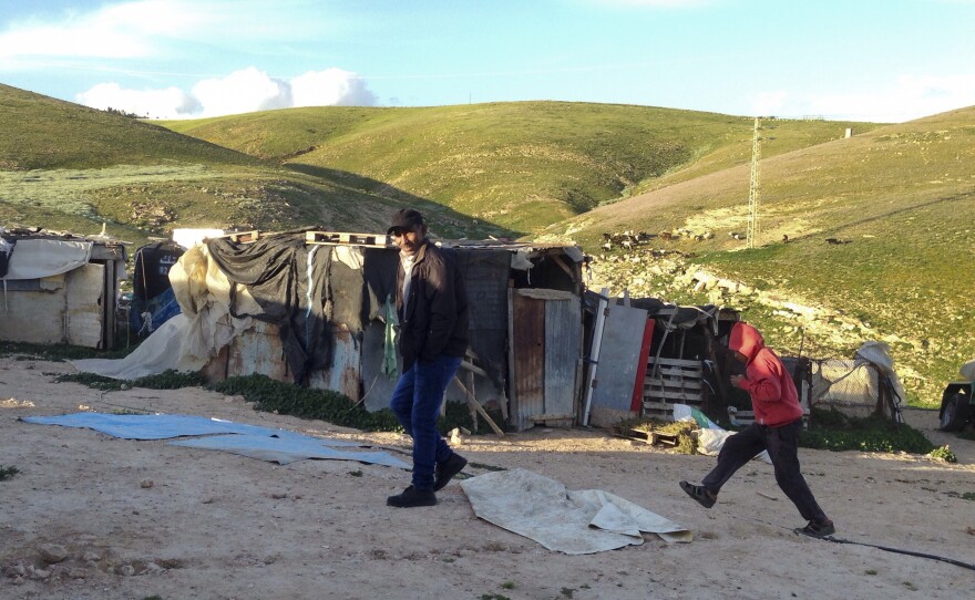 Eed Khamis, a Palestinian Bedouin, walks in an encampment in the Jordan Valley. He says Israelis diverted water supplies to serve nearby Jewish settlements, until Bedouins hammered holes in the pipes for access.