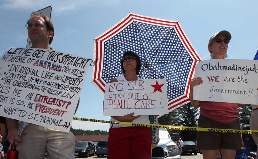 Protesters argue their positions on health care outside of President Obama's town hall meeting on Tuesday in Portsmouth, N.H.