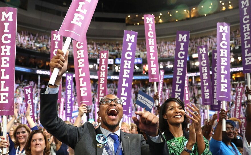 Delegates stand and cheer as first lady Michelle Obama speaks on the first day of the Democratic National Convention.