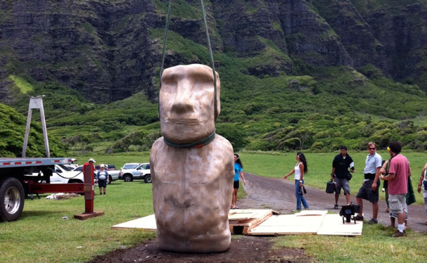 Moai re-creation held up by strap. The NOVA team tests the theory that the islanders used ropes to “walk” the statues upright, like moving a fridge.