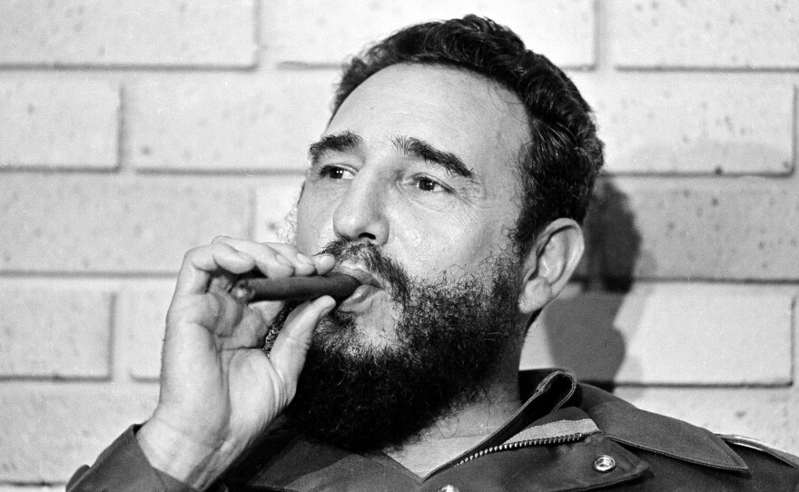 Castro smokes a cigar during his meeting with two U.S. senators, the first to visit Castro's Cuba, in Havana on Sept. 29, 1974.