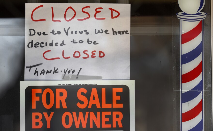 "For Sale By Owner" and "Closed Due to Virus" signs are displayed in a storefront in Grosse Pointe Woods, Mich. on April 2, 2020. The coronavirus has triggered a stunning collapse in the U.S. workforce.