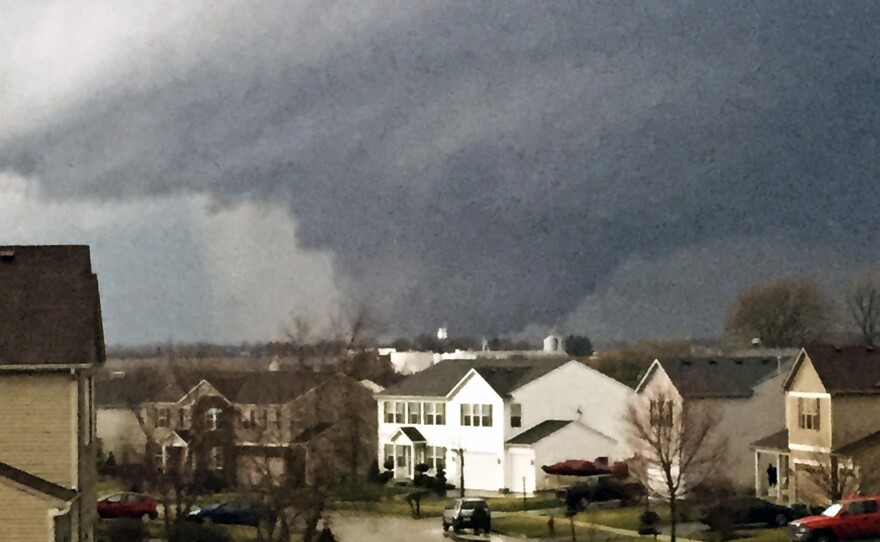 A tornado is viewed near Pearl Street from a home in Kirkland, Ill., Thursday. One person was killed in the tiny community of Fairdale, officials said.